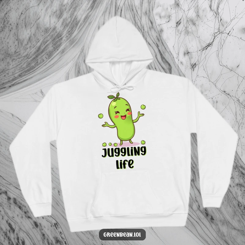 Funny green bean hoodie showing a cheerful character juggling peas, offering warmth and delightful veggie-themed playfulness. Soft and cozy.